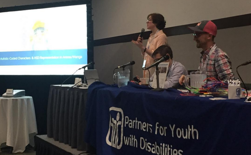 Jordan presenting in front of a crowd