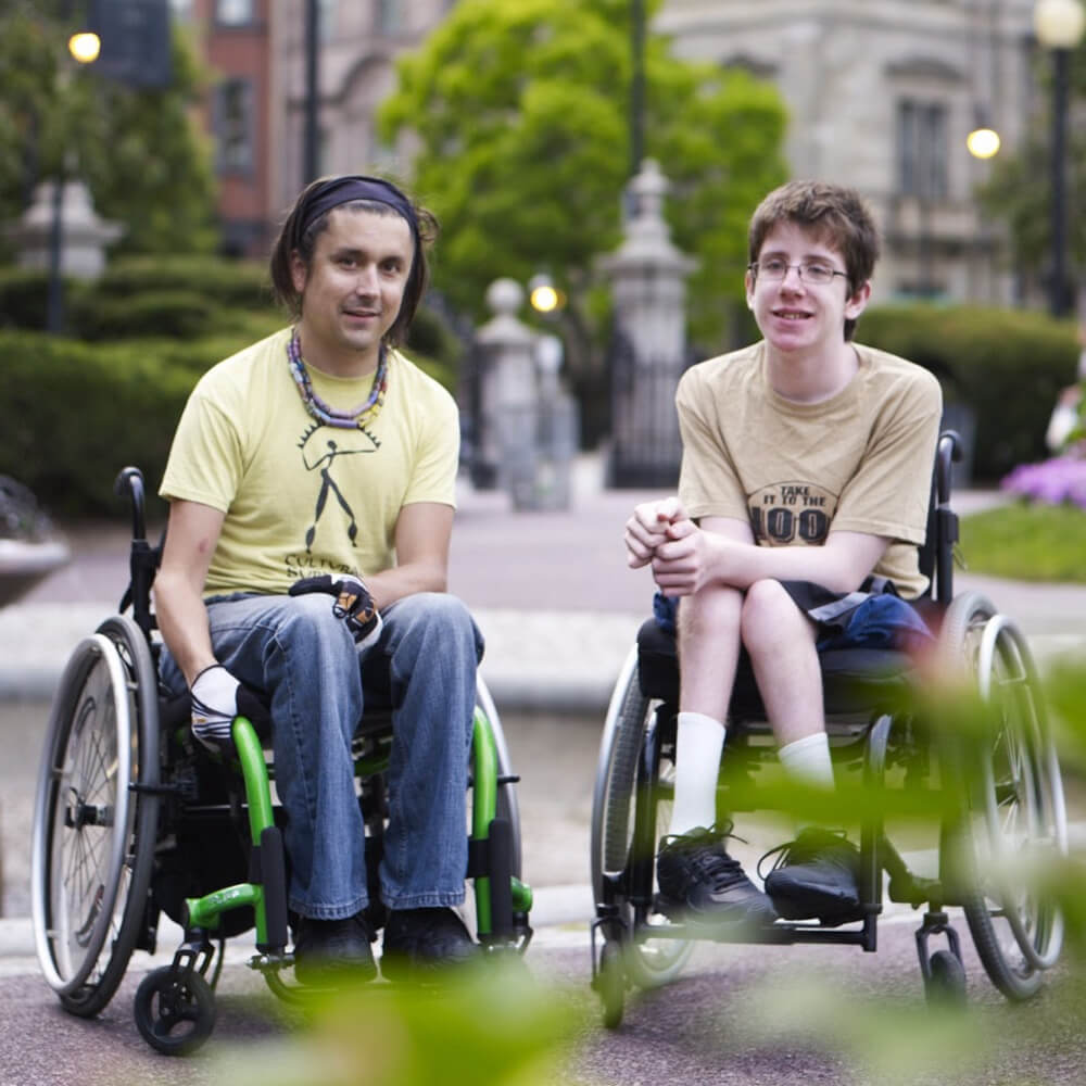 Two young adults hanging out in a park