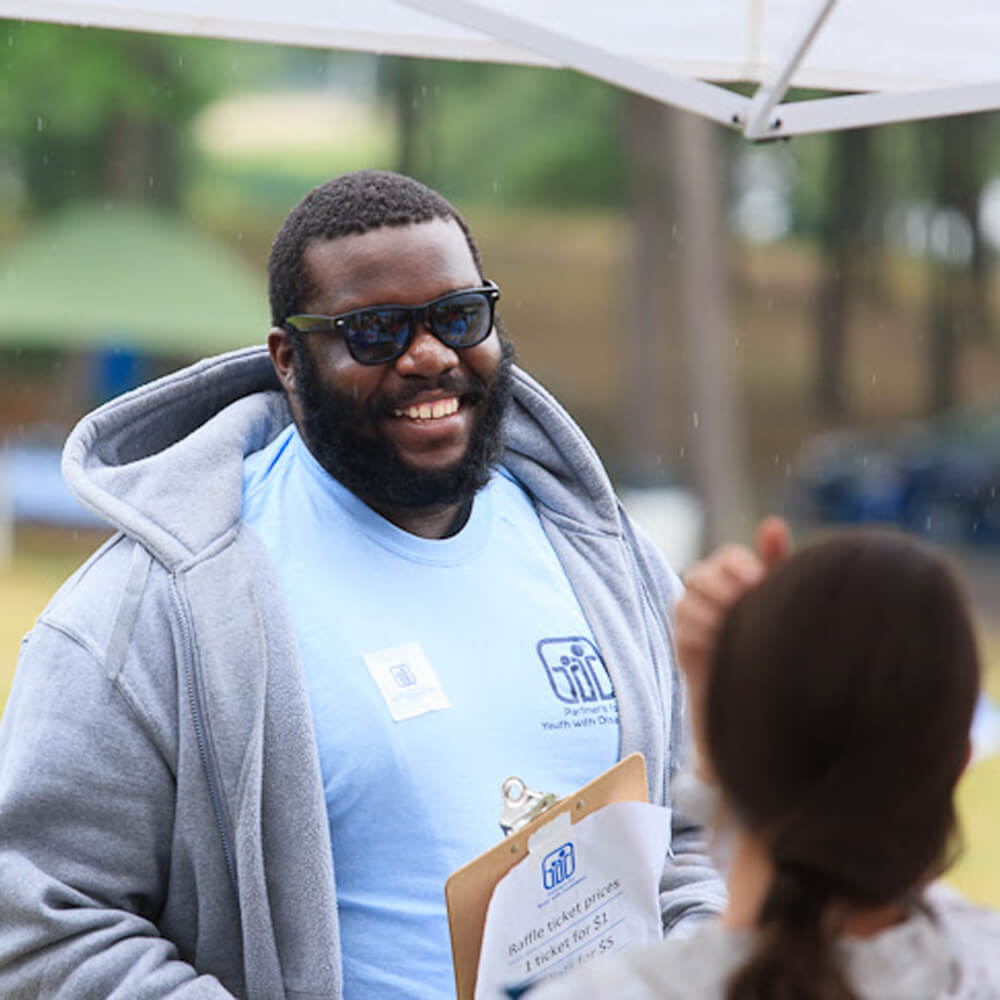 A PYD volunteer working at a fundraiser