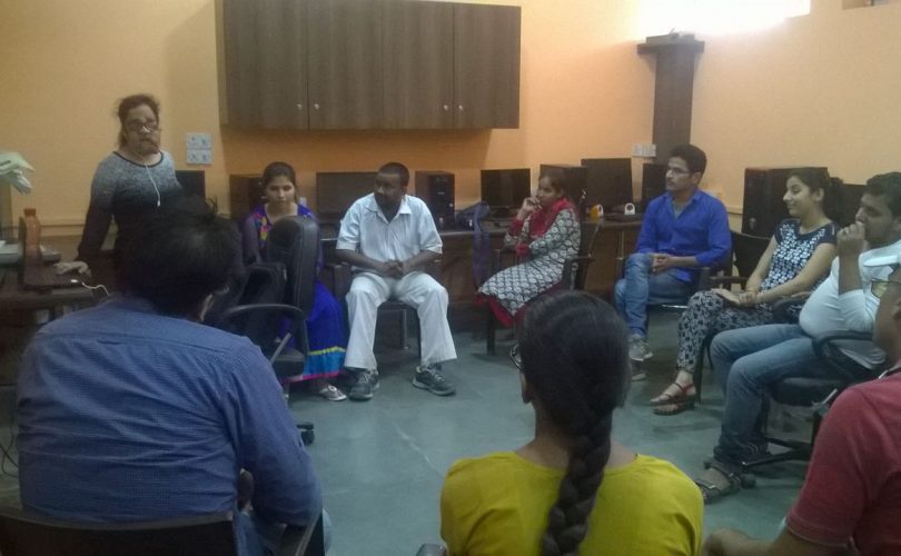 Vibhu speaking in front of a group circle