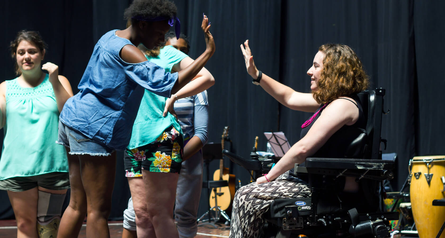 Two theater arts particiapants give each other a high five