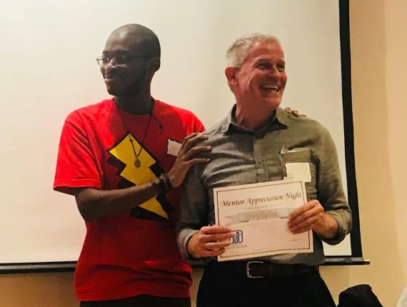 Mentee-mentor match Josh and Doug pose for a photo as they celebrate together at MAN 2018.