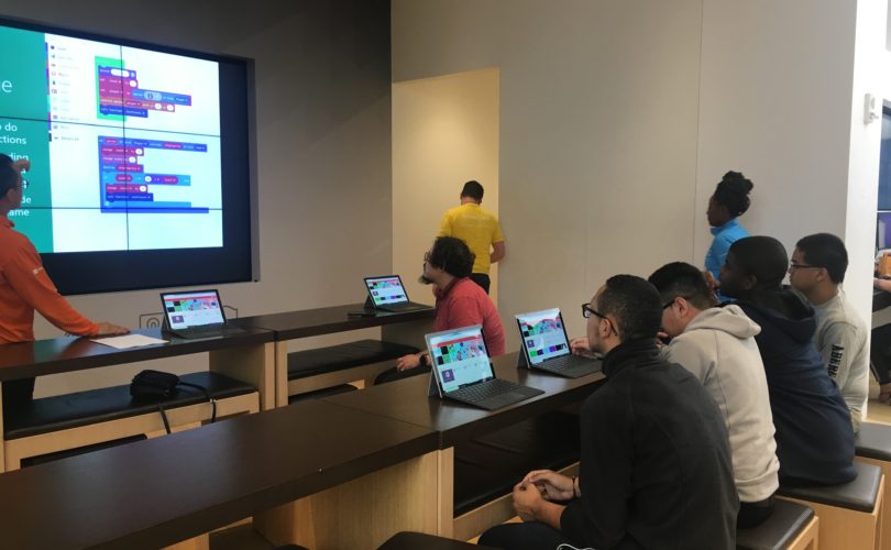 Four PYD youth sitting behind laptops