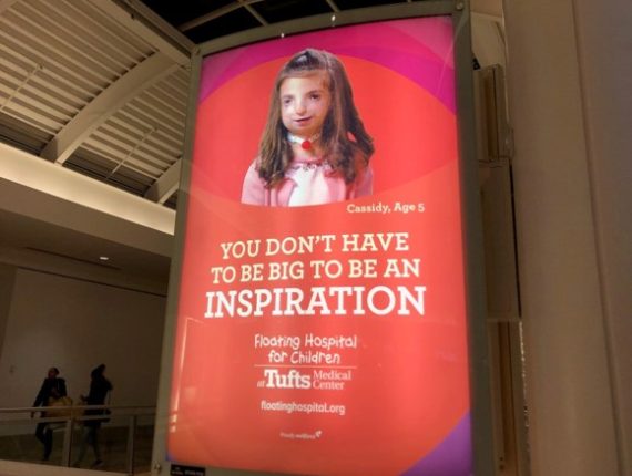 The image is an advertisement from Tufts Medical Center of a child with a visible disability that reads "You don't have to be big to be an inspiration. Floating Hospital for Children at Tufts Medical Center"