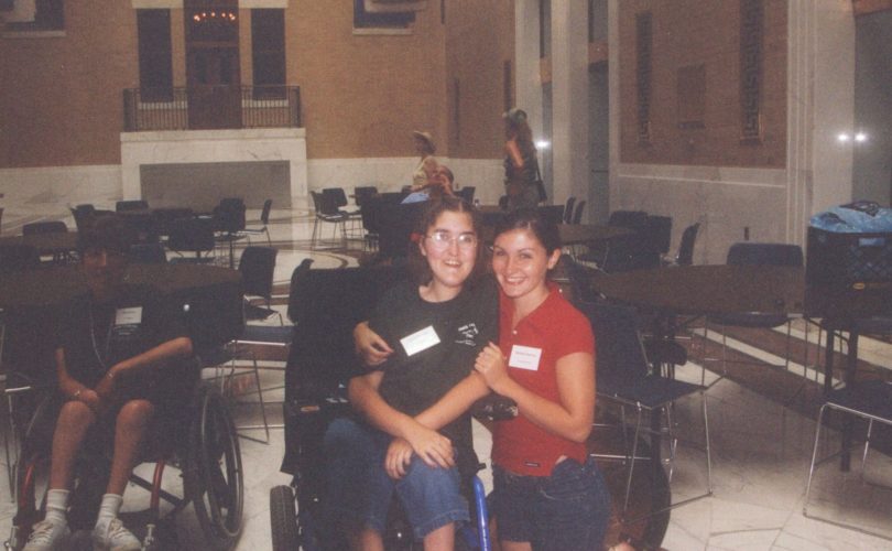 Sarah smiles alongside a friend