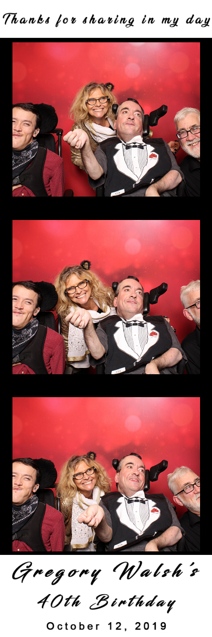 Austin, Regina, Gregory, and George smile in a photo-booth 