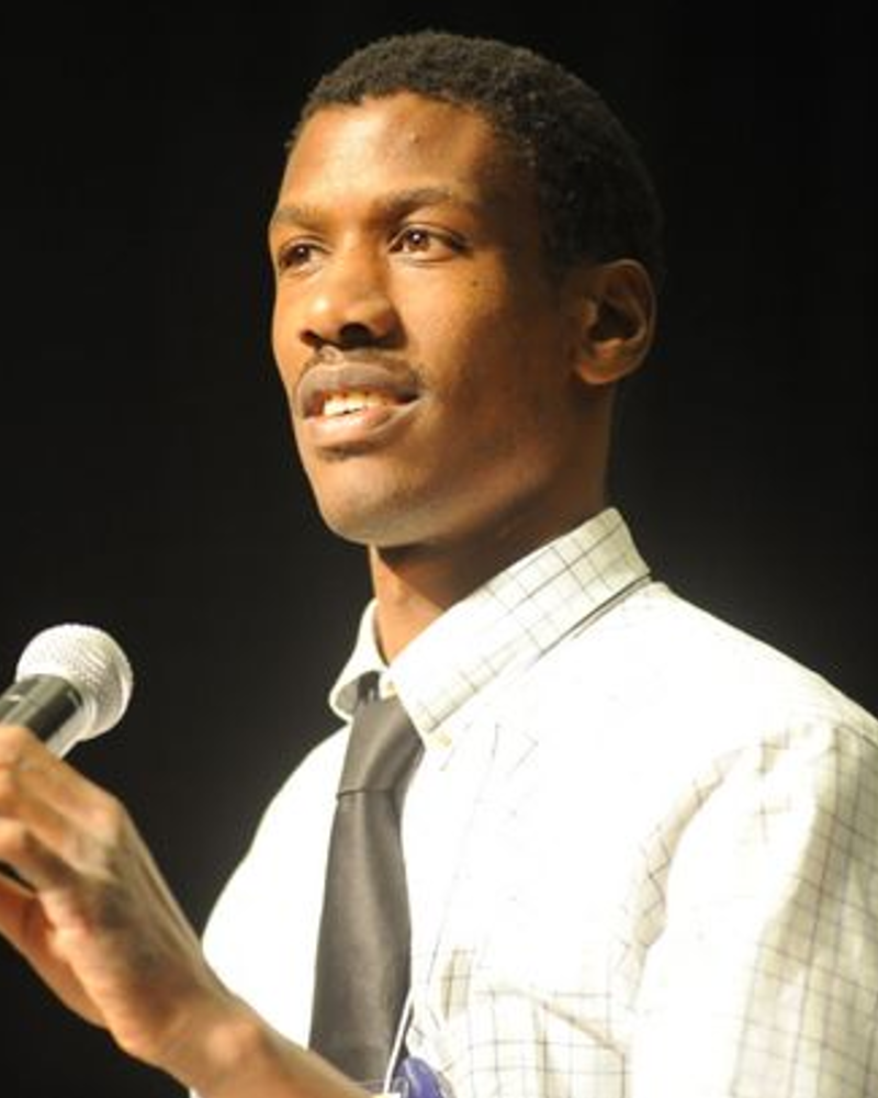 Headshot of Max Barrows speaking at a podium.