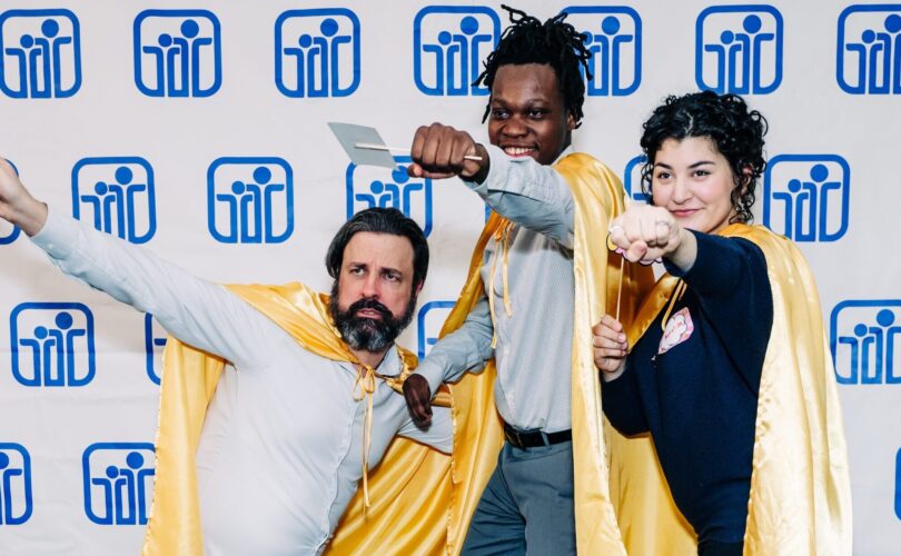 Three PYD 2024 Honors Night award recipients wearing gold capes and posing like superheroes!