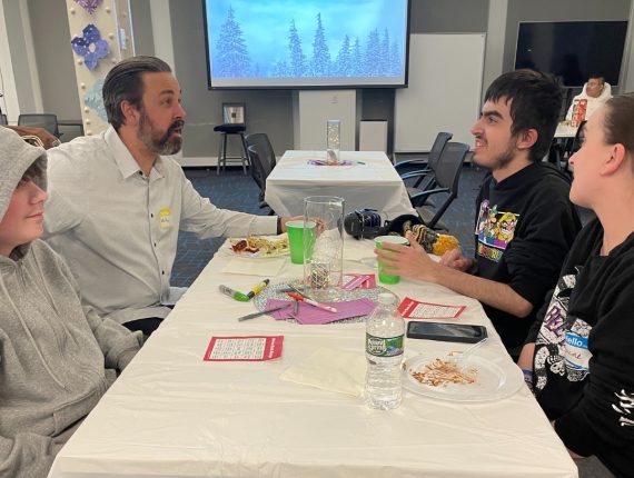 A family of four are talking to each other at the winter bash.