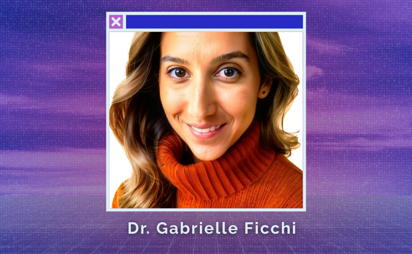 A photo of Dr. Gabrielle Ficci, against a white backdrop. She has wavy brown hair and a dark orange turtleneck sweater.