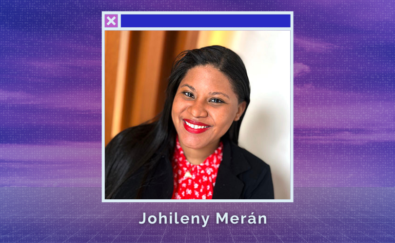 Portrait of Johileny. An afro-latina woman with long straight brown hair and eyes. She is wearing red lipstick, a black blazer over a red blouse with a small white floral pattern.